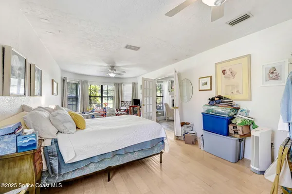 a bedroom with a bed couch and window