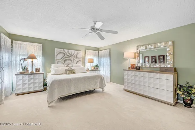 a living room with furniture and ceiling fan