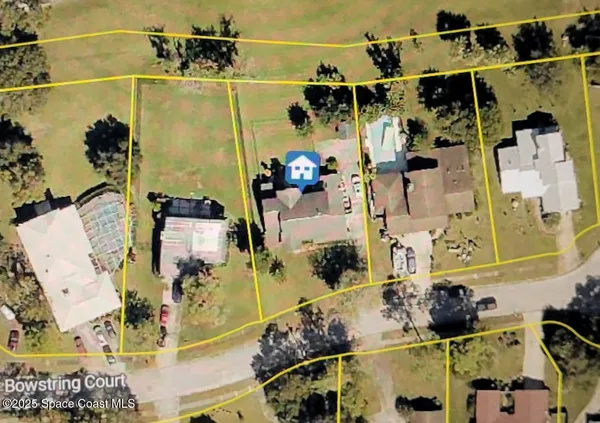 an aerial view of a house with a backyard