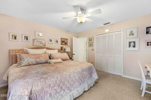 a large bedroom with a bed and a chandelier