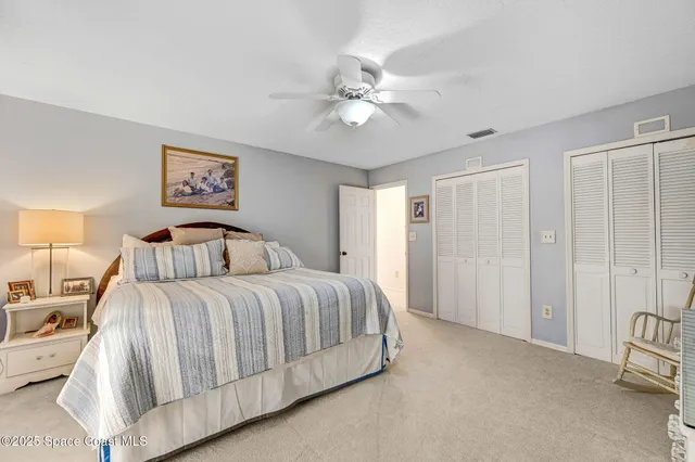 a spacious bedroom with a bed and a chandelier