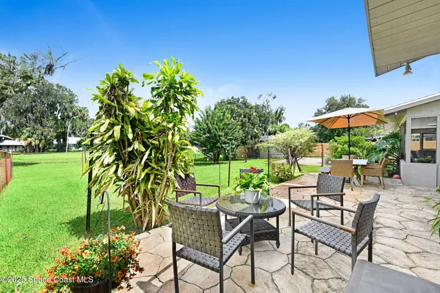 a view of a chairs and table in a yard