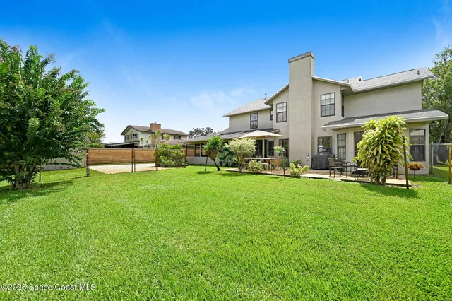 a view of a house with backyard sitting area and garden