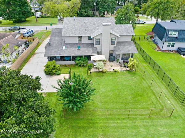 an aerial view of a house with swimming pool garden and patio