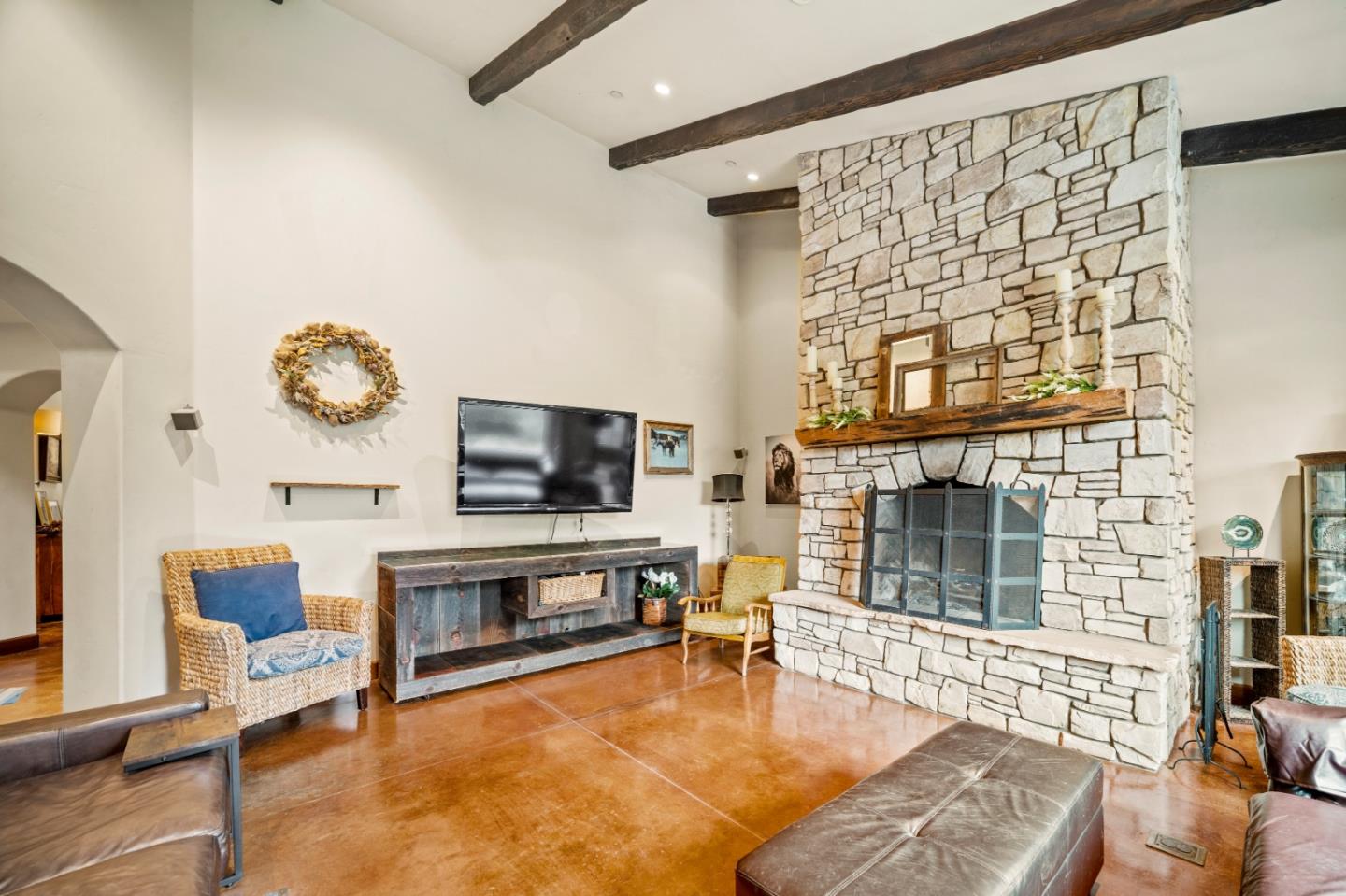 17551 Pond Derosa Lane Prunedale, CA 93907 - Photo 18 of 63 a living room with furniture a flat screen tv and a fireplace