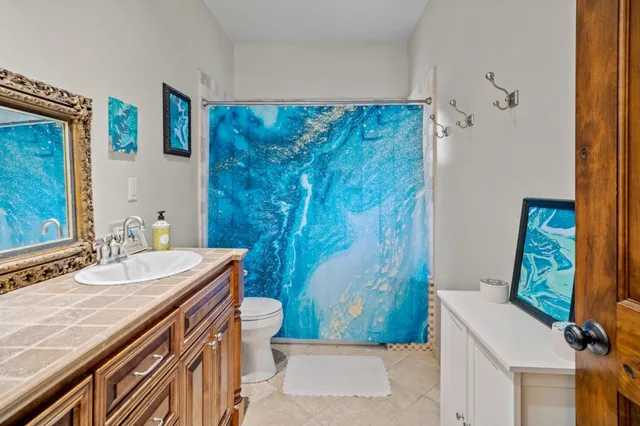a living room with furniture a flat screen tv and a window