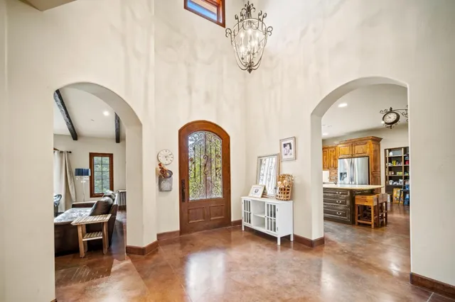 a kitchen with kitchen island granite countertop a sink a counter top space and stainless steel appliances