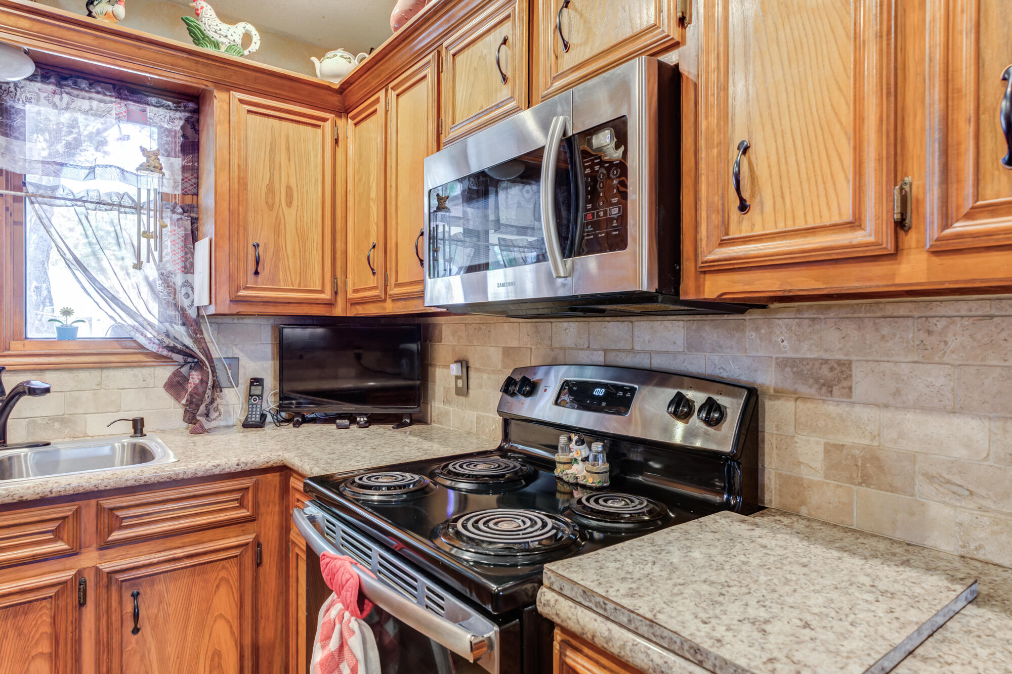 2213 86th Street Lubbock, TX 79423 - Photo 18 of 42 a kitchen with stainless steel appliances granite countertop a stove and a sink