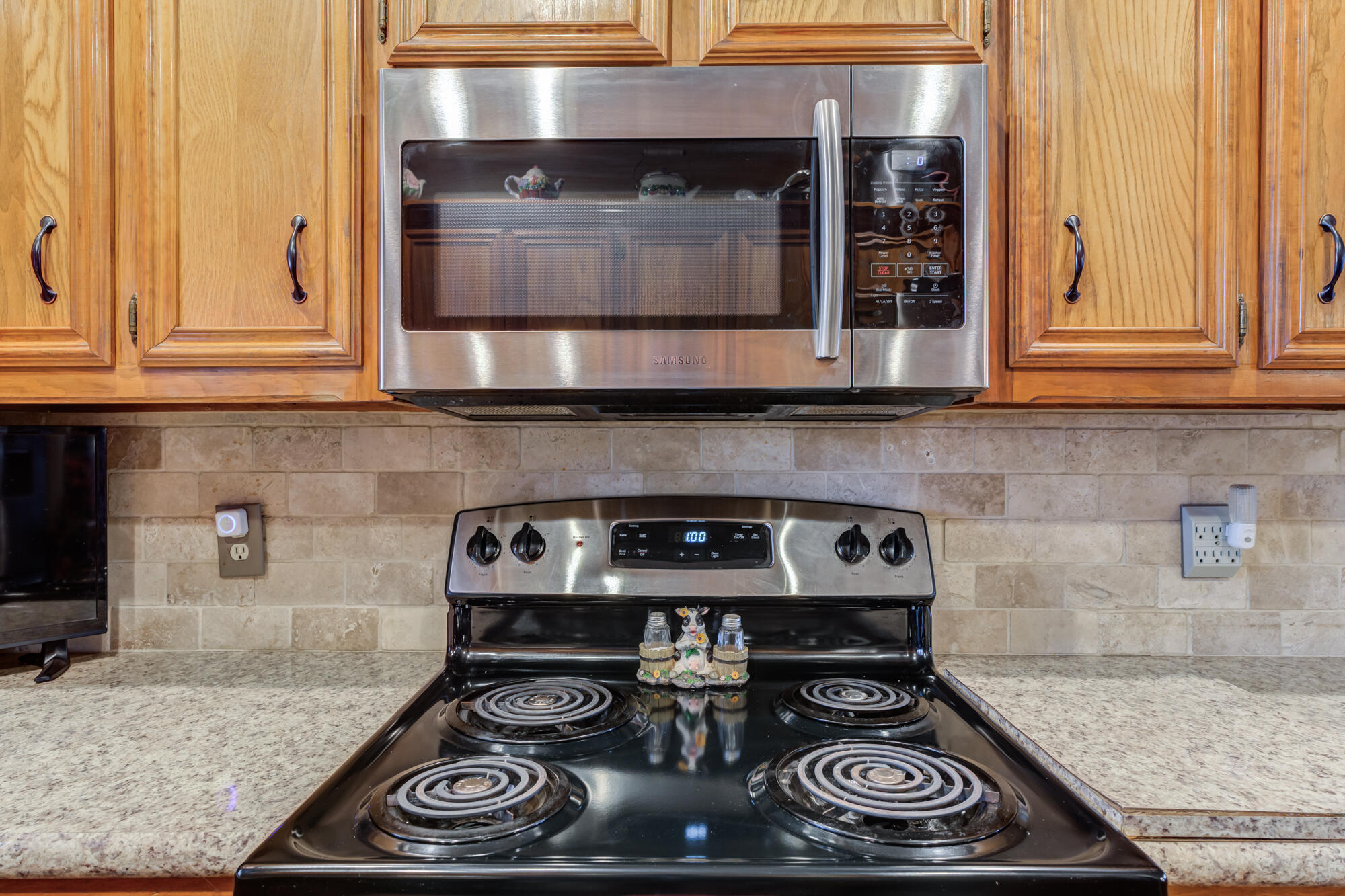 2213 86th Street Lubbock, TX 79423 - Photo 19 of 42 a kitchen with a stove and cabinets