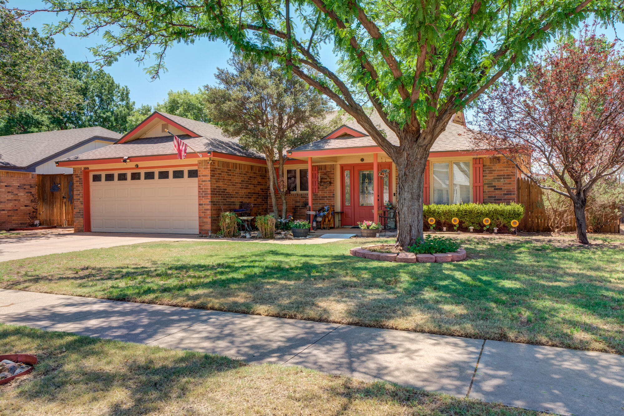 2213 86th Street Lubbock, TX 79423 - Photo 2 of 42 a front view of a house with garden