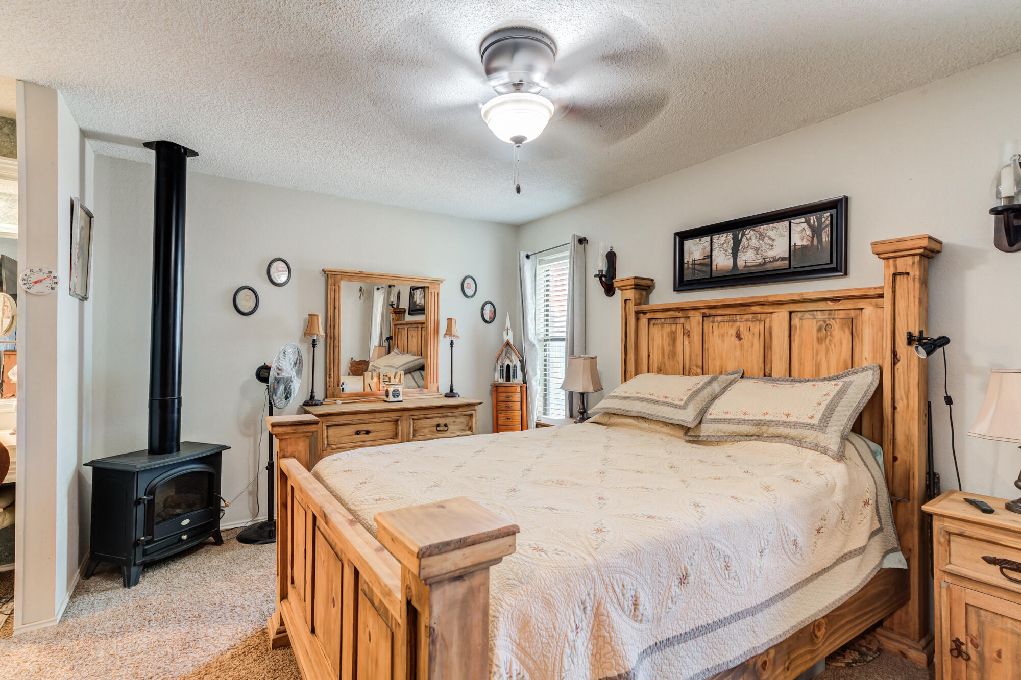 2213 86th Street Lubbock, TX 79423 - Photo 23 of 42 a bedroom with a bed and a chandelier