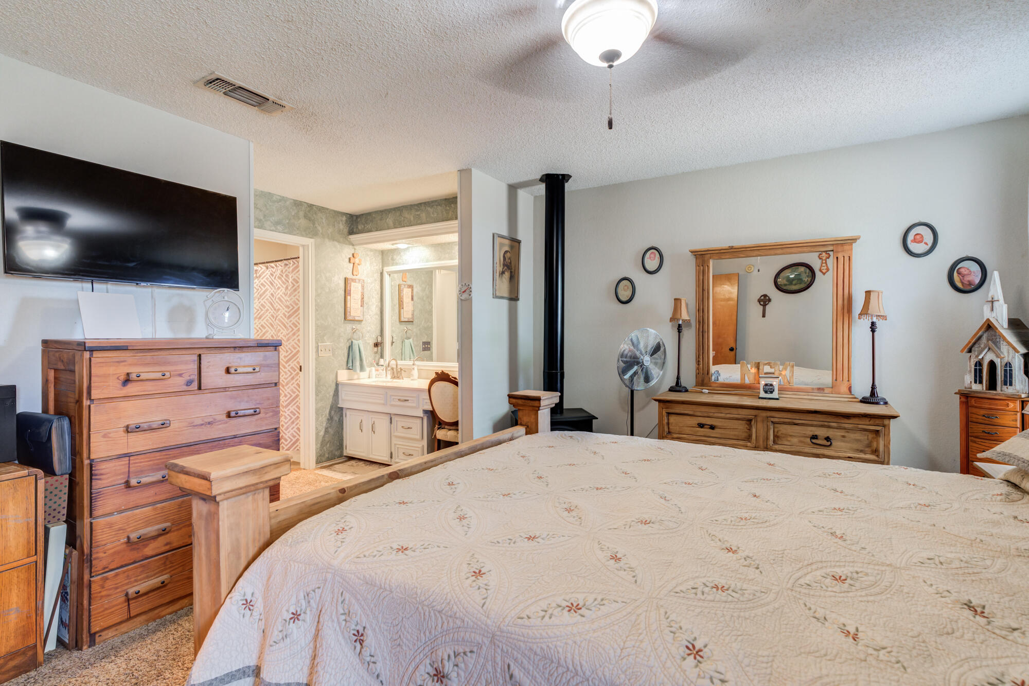 2213 86th Street Lubbock, TX 79423 - Photo 24 of 42 a bedroom with a bed and a flat screen tv