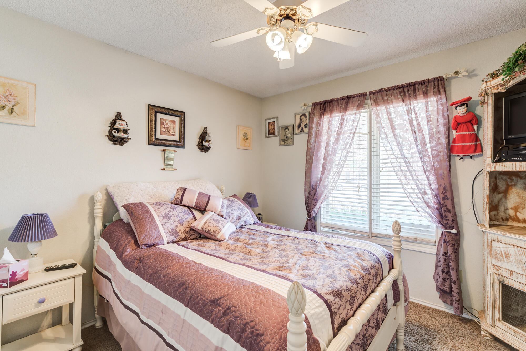 2213 86th Street Lubbock, TX 79423 - Photo 26 of 42 a bedroom with a bed and a flat screen tv