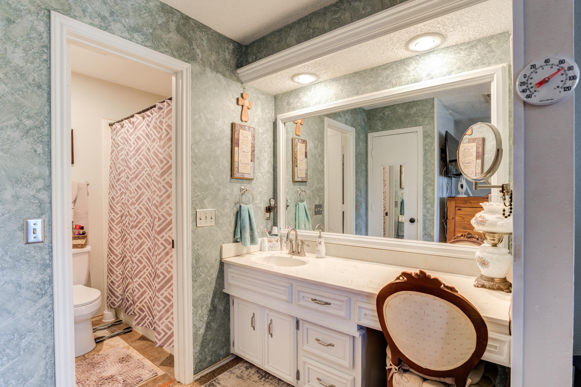 2213 86th Street Lubbock, TX 79423 - Photo 28 of 42 a bathroom with a granite countertop toilet a sink a mirror a and shower