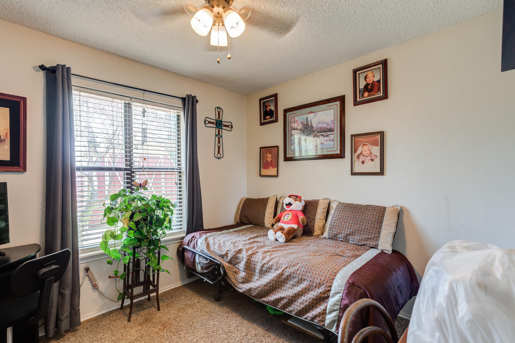 2213 86th Street Lubbock, TX 79423 - Photo 29 of 42 a bedroom with a bed and a chandelier