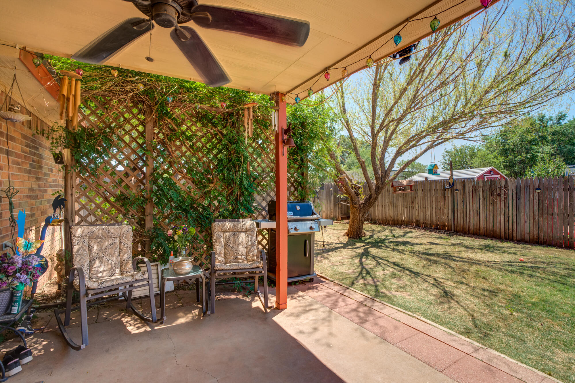 2213 86th Street Lubbock, TX 79423 - Photo 33 of 42 a backyard of a house with table and chairs