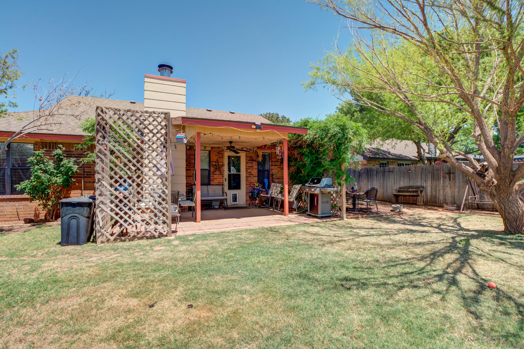 2213 86th Street Lubbock, TX 79423 - Photo 35 of 42 a view of a chairs and table in the patio and a fountain