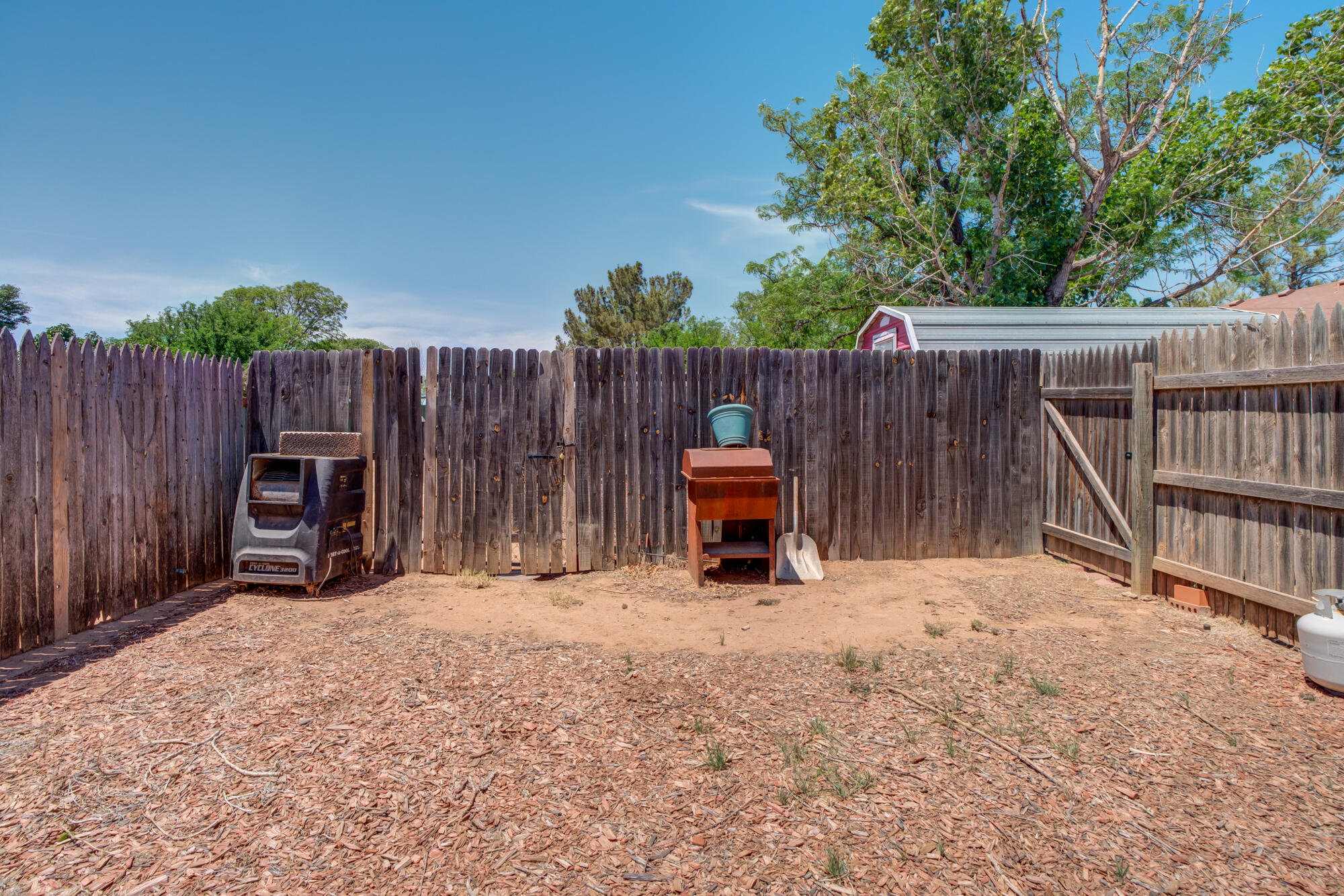2213 86th Street Lubbock, TX 79423 - Photo 41 of 42 a view of backyard with wooden fence and a large tree