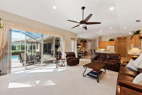 a living room with furniture gym equipment and a large window