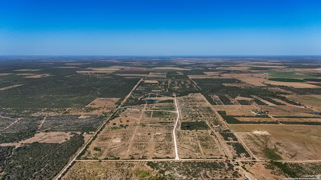 a sign board with a trees in the background