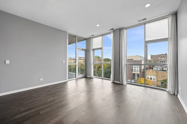 a view of room with floor to ceiling window and wooden floor