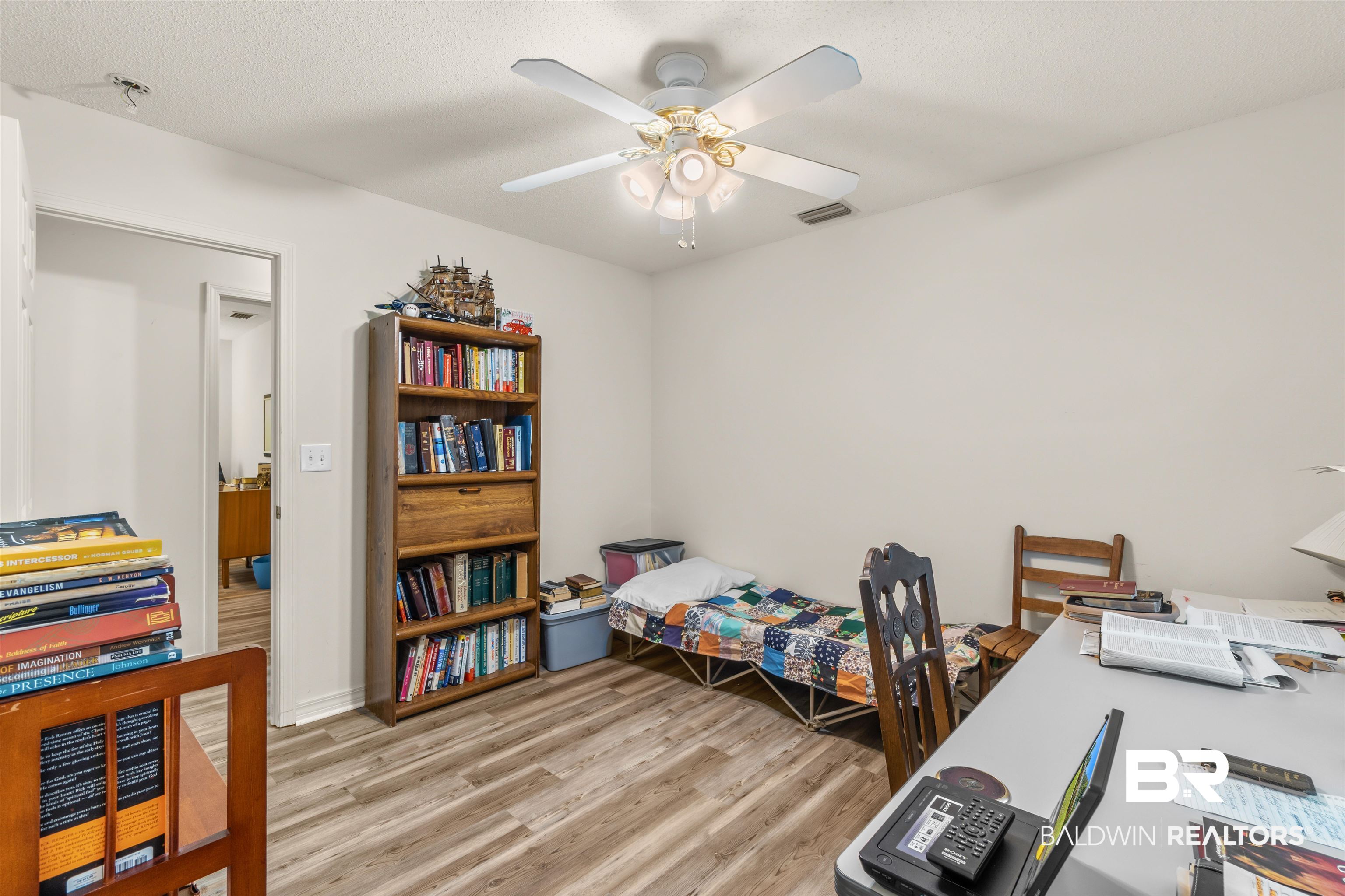 35893 Pine Road South Stapleton, AL 36578 - Photo 21 of 31 Neutral wall tones, wood-finish flooring, and a ceiling fan with integrated lighting