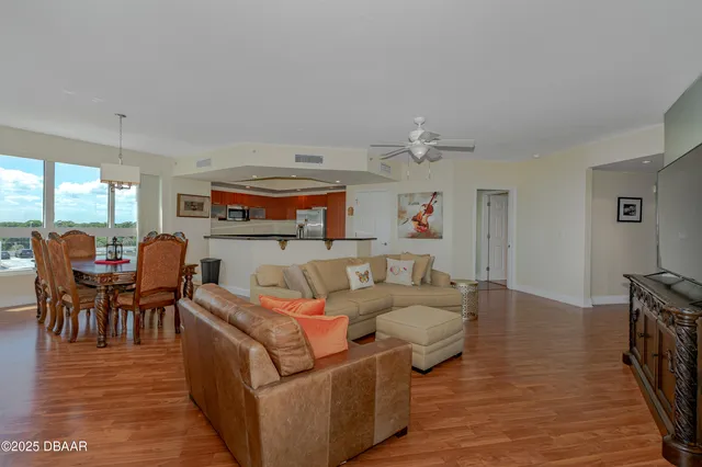 a living room with furniture and wooden floor