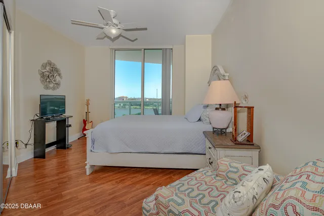 a bedroom with a large bed and a chandelier