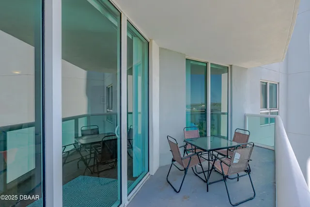 a view of a room that has a mirror and a chair in it
