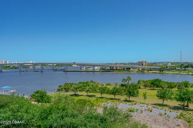 a view of a lake with houses in the back