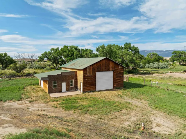 a house with huge green field in front of it