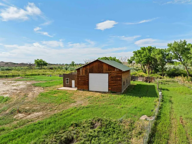a large house with a big yard and large trees