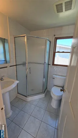 a bathroom with a toilet a sink a vanity and mirror