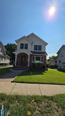a front view of a house with a garden and yard