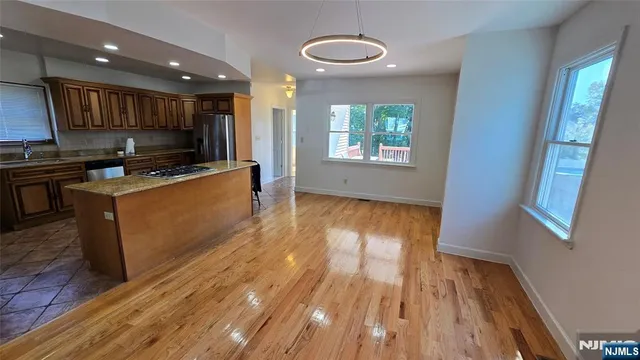 a view of kitchen with wooden floor and electronic appliances