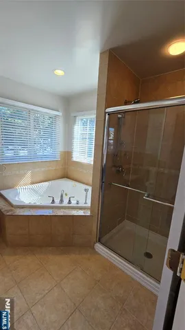 a bathroom with bathtub and shower