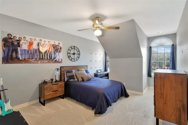 a living room with furniture and a ceiling fan
