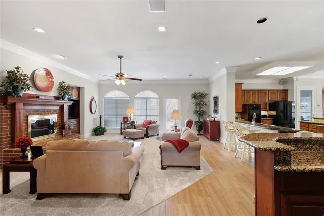 a living room with fireplace furniture and a chandelier