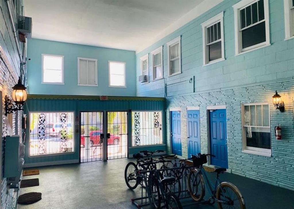 a living room with furniture a flat screen tv and windows