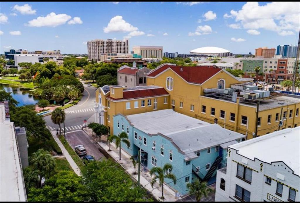 308 Grove Street North, Unit 206 St. Petersburg, FL 33701 - Photo 2 of 12 an aerial view of a house with a yard and lake view