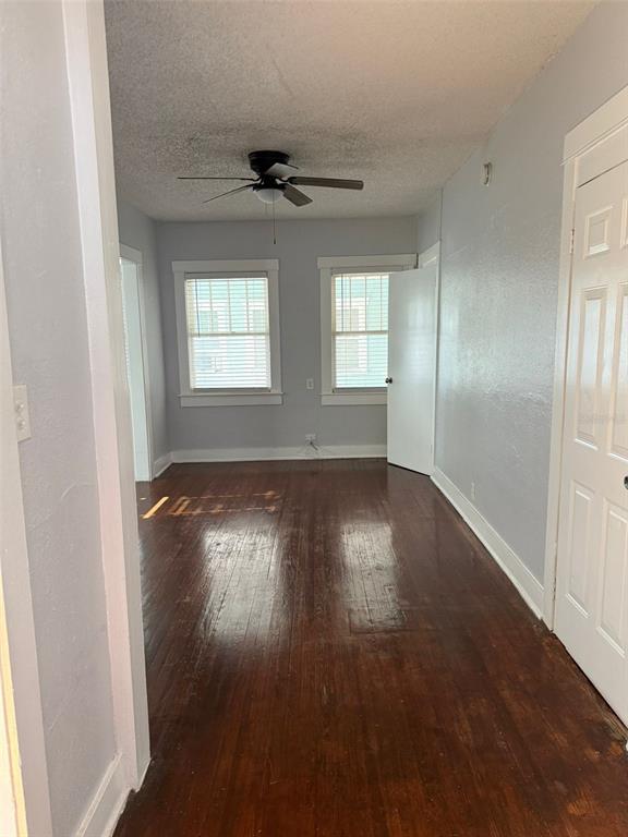 308 Grove Street North, Unit 206 St. Petersburg, FL 33701 - Photo 5 of 12 an empty room with wooden floor and windows