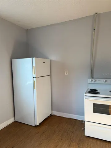 a white refrigerator freezer sitting in a kitchen
