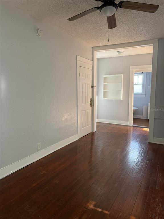 308 Grove Street North, Unit 206 St. Petersburg, FL 33701 - Photo 10 of 12 a view of an empty room with wooden floor and a window