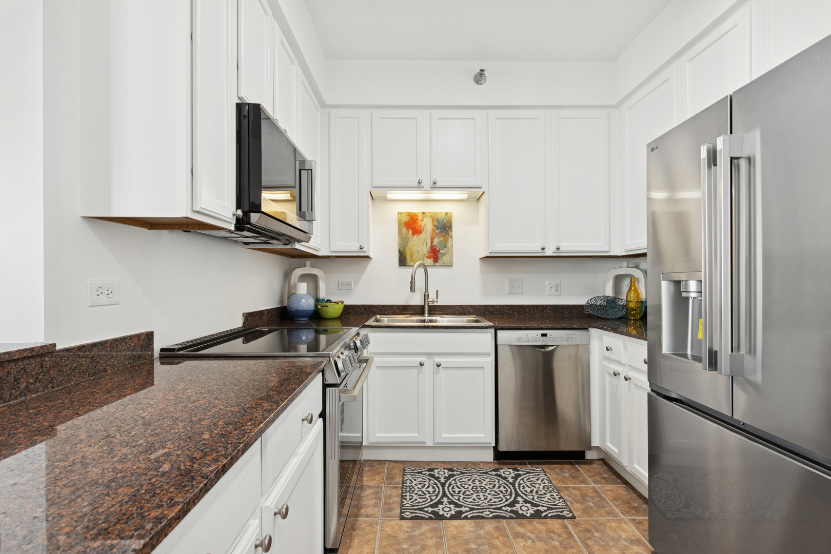 435 West Erie Street, Unit 1408 Chicago, IL 60654 - Photo 6 of 21 a kitchen with stainless steel appliances granite countertop a sink stove and refrigerator