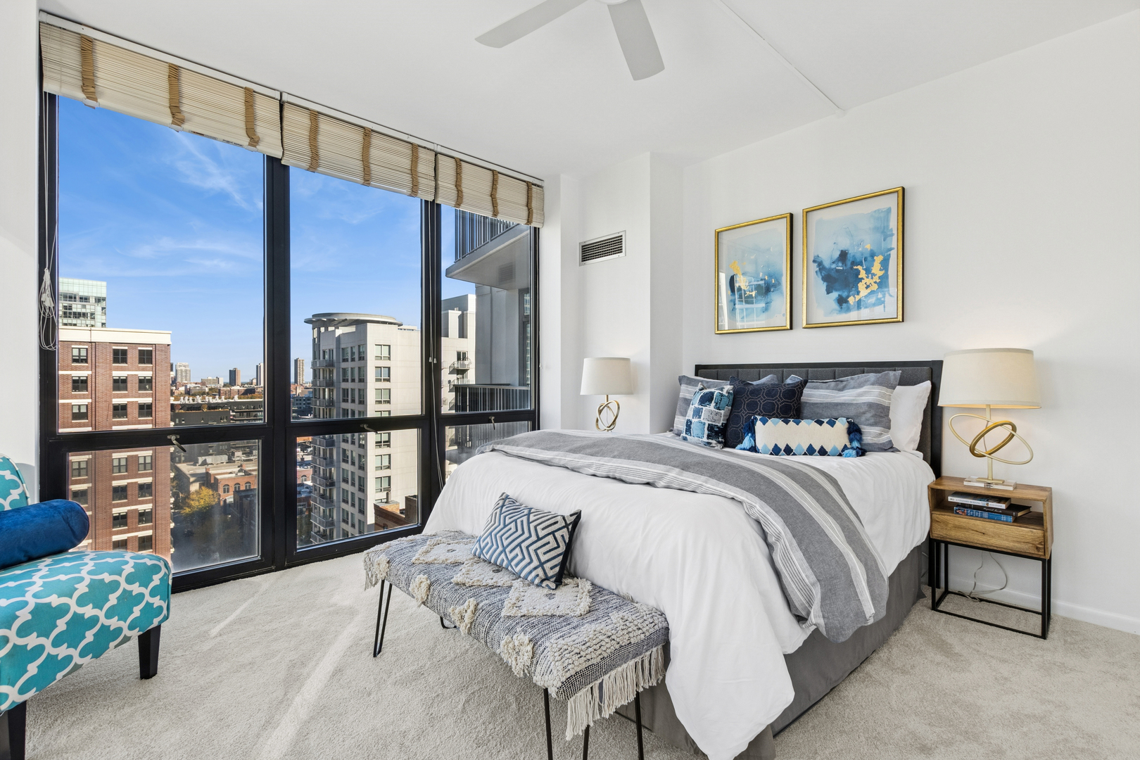 435 West Erie Street, Unit 1408 Chicago, IL 60654 - Photo 9 of 21 a bedroom with a large bed and a chandelier