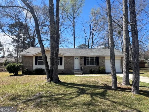 a view of a house with a yard covered in snow