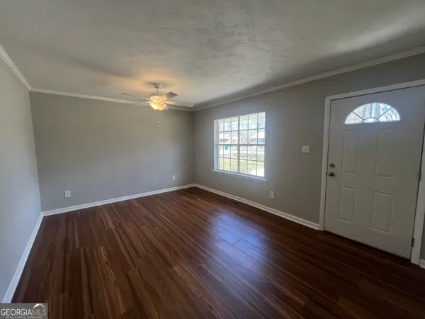 wooden floor in an empty room with a window