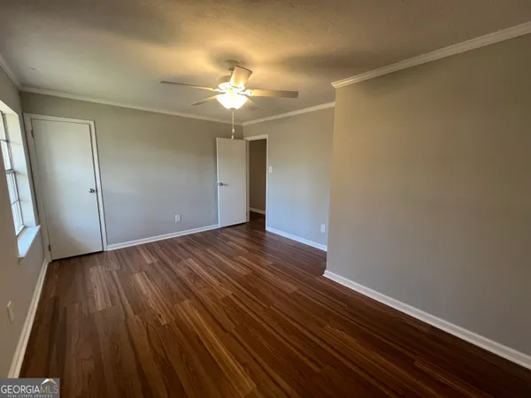 wooden floor in an empty room with a window