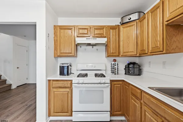 a kitchen with a stove top oven sink and cabinets