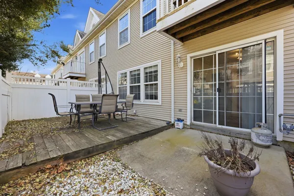 a view of a patio with table and chairs and potted plants